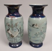 A PAIR OF CHINESE STYLE BALUSTER VASES with flared necks and having blue and green glaze with