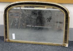 AN ARCHED OVERMANTEL MIRROR with gilding and black paint-work with continuous floral band, circa