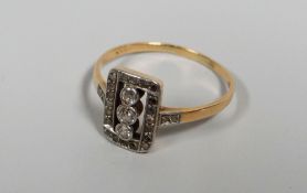 A 14K GOLD DIAMOND CLUSTER RING the diamonds in a rectangular arrangement with a row of three centre