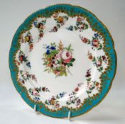 A PORCELAIN PLATE WITH PAINTED FLORAL SPRAY and having a turquoise border, gilding and further