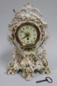 A CONTINENTAL PORCELAIN CLOCK of elaborate form with applied openwork finial and four mounted
