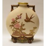 A ROYAL WORCESTER MOON FLASK having twin handles and raised on four feet in ivory ground and