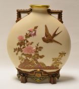 A ROYAL WORCESTER MOON FLASK having twin handles and raised on four feet in ivory ground and