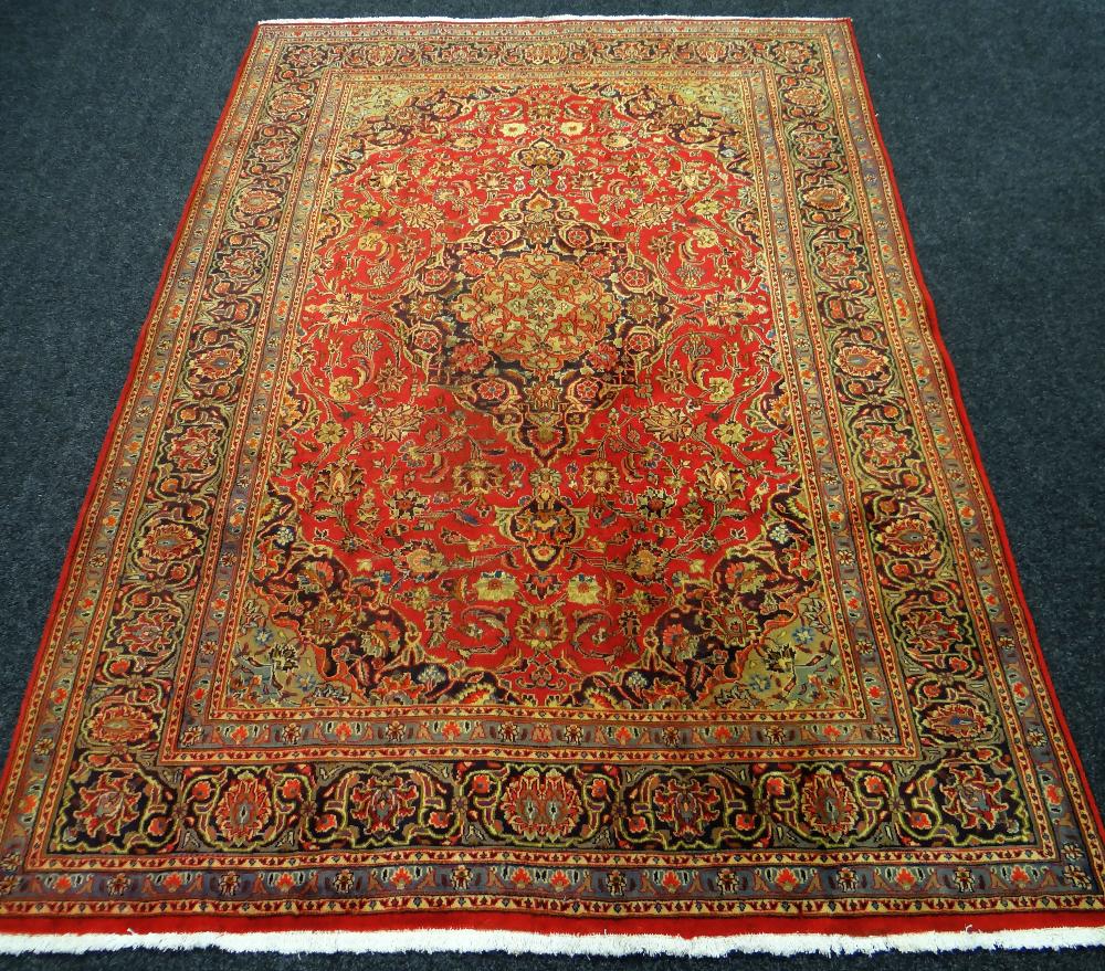 RED GROUND PERSIAN KASHAN CARPET with traditional Kashan medallion design, 294 x 196cms