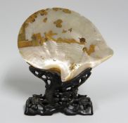 A JAPANESE MOTHER-OF-PEARL TABLE-SCREEN on a naturalistic carved hardwood stand, the shell gold