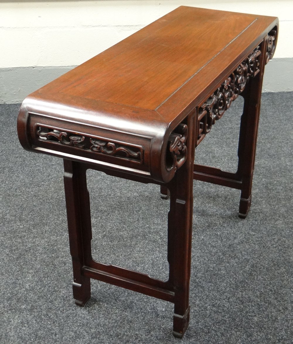 A CHINESE ROSEWOOD ALTAR TABLE having a fretwork frieze and rolled ends, 114cms wide - Image 2 of 2