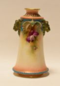 A HADLEY WORCESTER TAPERED VASE with twin lion-head handles and painted with flowers, 14cms high