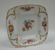 A SWANSEA PORCELAIN SQUARE DISH with five sprays of colourful flowers and gilded scrolls, no marks