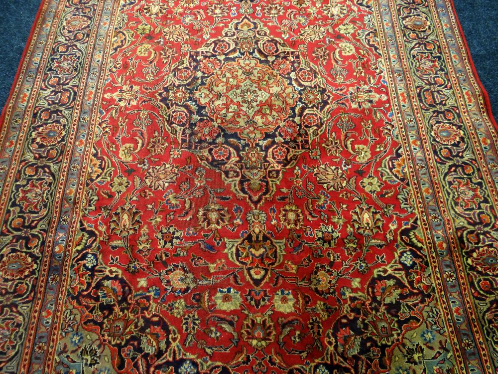 RED GROUND PERSIAN KASHAN CARPET with traditional Kashan medallion design, 294 x 196cms - Image 2 of 3