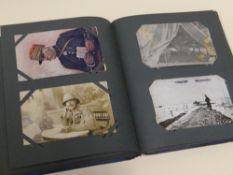A POSTCARD ALBUM OF EDWARDIAN POSTCARDS comprising many British and German WWI cards of uniformed