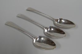 THREE GEORGE III SILVER SERVING SPOONS, of plain-form with crests to the terminals London 1772, 5.