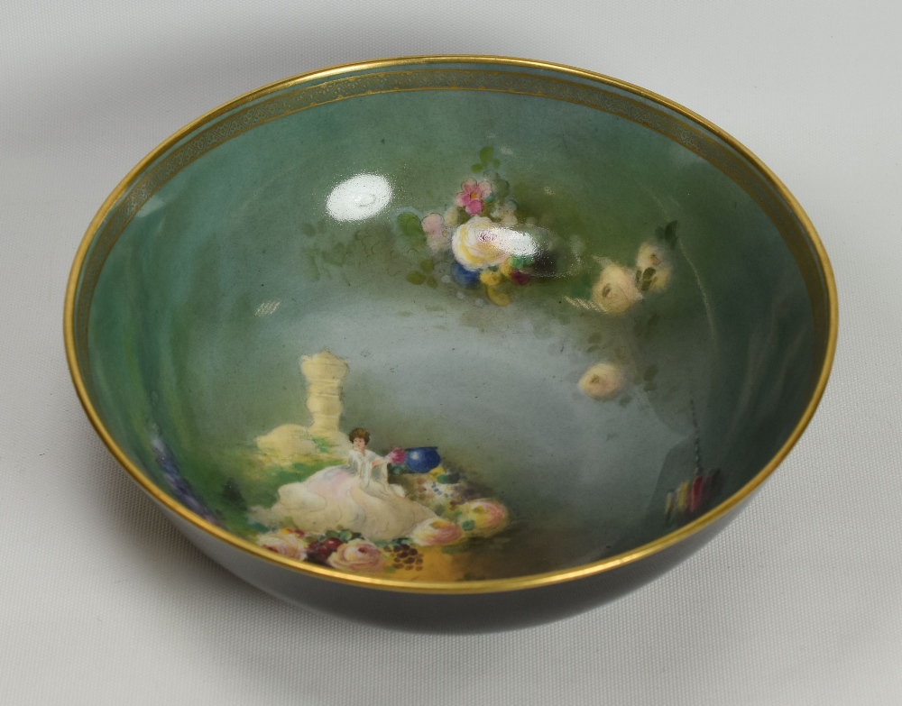 A ROYAL DOULTON FOOTED BOWL with black outer glaze, the interior decorated with a gardening figure