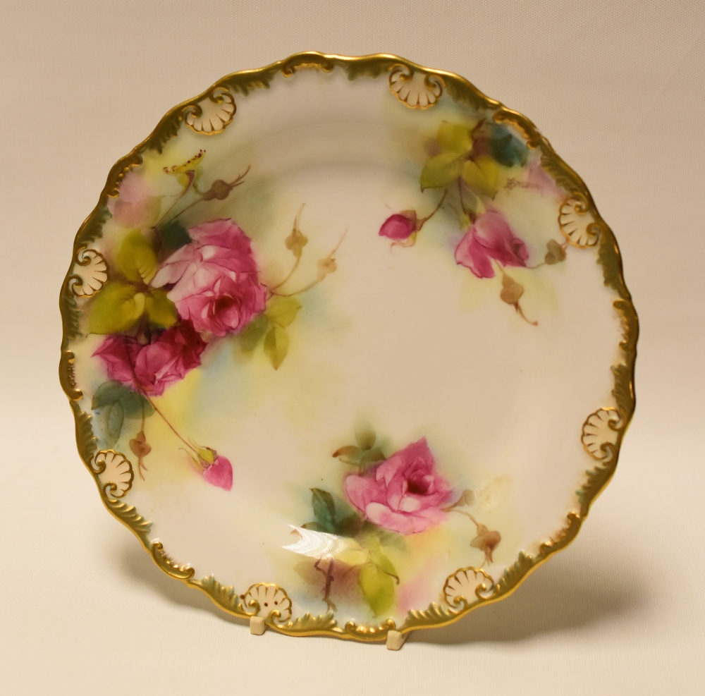 A ROYAL WORCESTER CABINET PLATE painted with three sprays of pink roses by S Pillsbury, signed, date