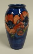 A MOORCROFT ANEMONE BALUSTER VASE in blue ground with a necklace of tube-lined flowers with 'Potters