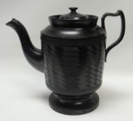 A NINETEENTH CENTURY BLACK BASALT COFFEE POT on a circular base and with incised decoration to the