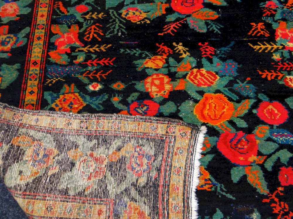 AN ANTIQUE PERSIAN CARPET of black ground with floral decoration, 233 x 130cms - Image 3 of 3