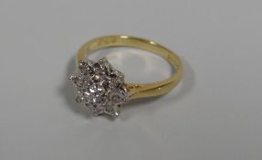 AN 18CT DIAMOND FLORAL CLUSTER RING of nine diamonds, 3.47gms