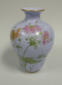 A ROYAL WORCESTER BLUE GLAZED VASE painted with wild-flowers rising upwards, date mark includes