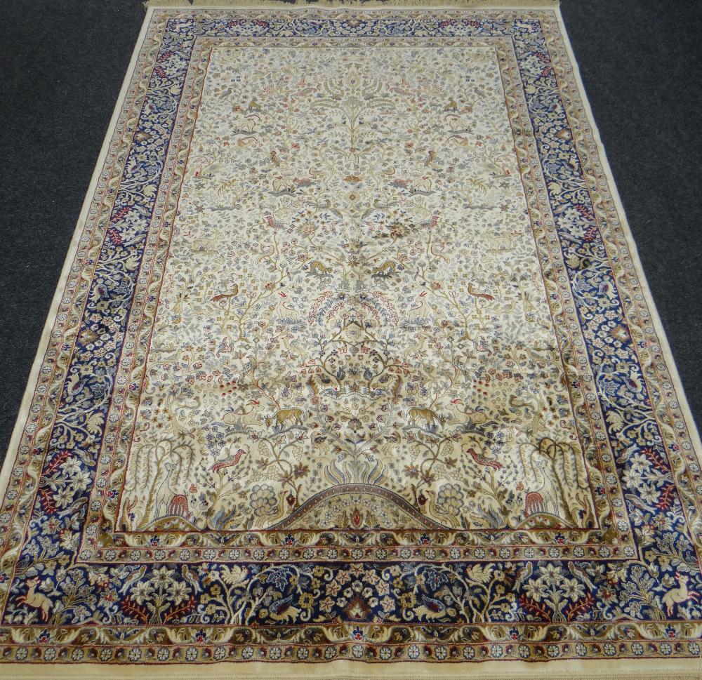 AN IVORY GROUND CASHMERE CARPET tree of life design with unique blue border, 301 x 194cms