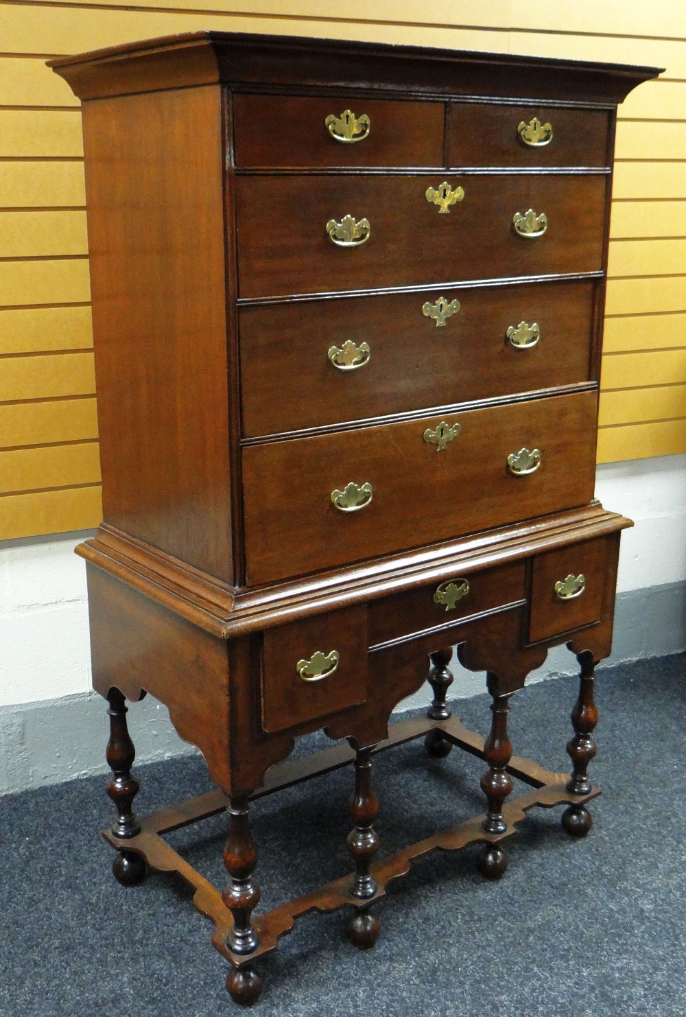 A NINETEENTH CENTURY OAK CHEST-ON-STAND, the top with three graduated drawers below two short, the