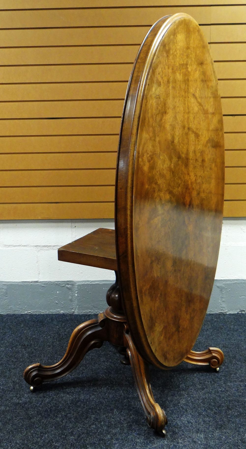 A VICTORIAN OVAL WALNUT BREAKFAST TABLE with tilt-top mechanism on four scroll supports, 58cms long - Image 2 of 3