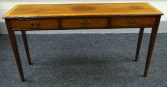 A REPRODUCTION MAHOGANY SIDE TABLE with three drawers, 136cms wide