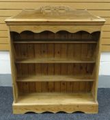 A PINE OPEN BOOKCASE with openwork carved rail, 107cms wide