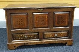 A WELSH INLAID OAK BLANKET CHEST of tri-panelled form and with a pair of base drawers bearing lion