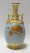 A ROYAL WORCESTER POWDER BLUE TWIN-HANDLED VASE decorated with gilded flowers and with yellow glazed