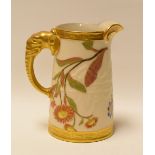 A ROYAL WORCESTER JUG WITH ELEPHANT HANDLE in blush ivory, gilding and with painted flowers, 13cms