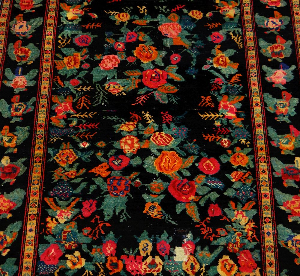 AN ANTIQUE PERSIAN CARPET of black ground with floral decoration, 233 x 130cms - Image 2 of 3