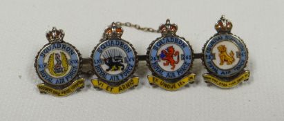 AN ENAMEL & WHITE GOLD RAF BROOCH composed of four circular squadron coat-of-arms with titles, Latin