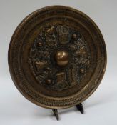 A CHINESE TANG STYLE BRONZE MIRROR of circular form decorated in relief with alternate rickshaws and