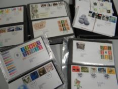 A LARGE QUANTITY OF 1ST DAY COVERS in albums and loose in envelopes together with a quantity of