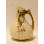 A ROYAL WORCESTER BLUSH IVORY JUG with gilded naturalistic handle and painted with wild-flowers,