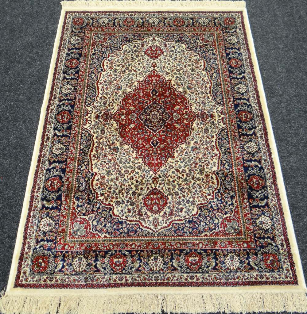 AN IVORY GROUND CASHMERE RUG with medallion design, 159 x 116cms