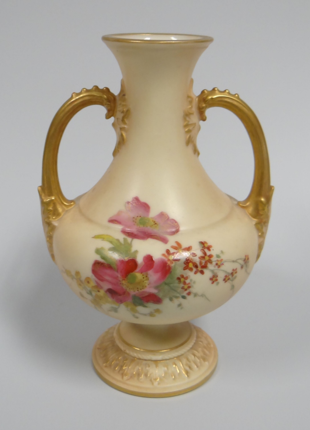 A SMALL ROYAL WORCESTER BLUSH VASE with twin-handles on a circular foot and the body painted with