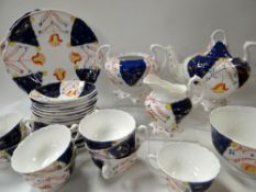 THIRTY PIECE GAUDY WELSH STAFFORDSHIRE TEA-SET in the tulip pattern