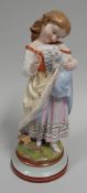 A LARGE CONTINENTAL PORCELAIN FIGURE OF A GIRL looking adoringly at a kitten she is holding in