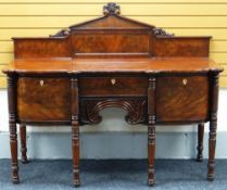 AN EMPIRE FLAME MAHOGANY SIDEBOARD with centre drawer flanked by two deep drawers and having a