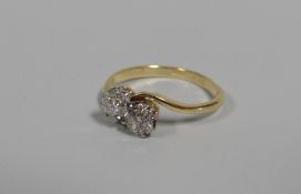 AN 18CT YELLOW GOLD & PLATINUM DIAMOND CROSS-OVER RING, diamond visual estimate 0.35ct x 2, 2.47gms