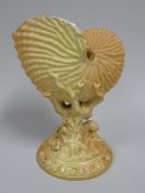 A ROYAL WORCESTER BLUSH SHELL VASE raised upon a circular foot and of naturalist form, dated 1894,