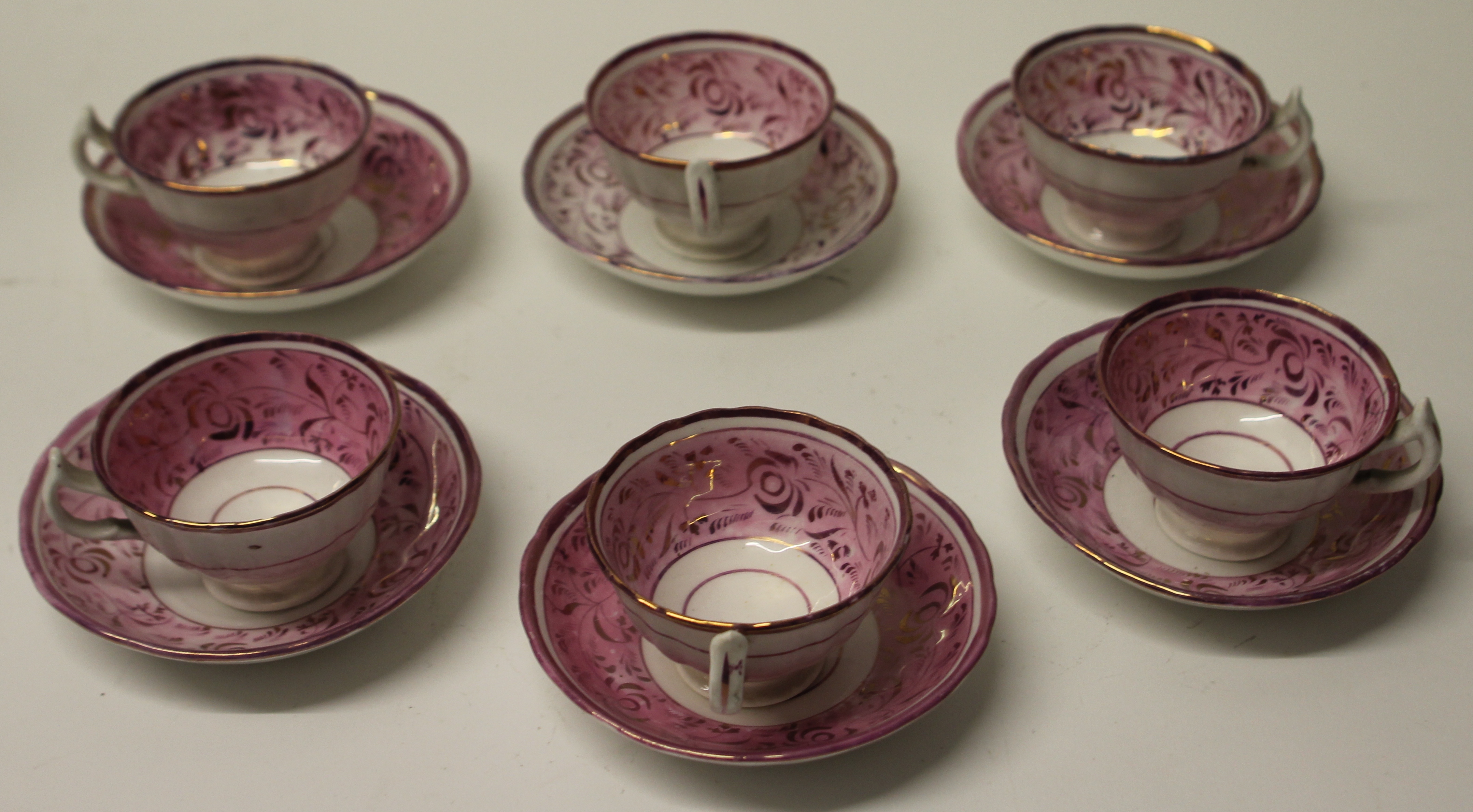 A SET OF SIX SUNDERLAND LUSTRE CUPS AND SAUCERS