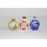 Drei Snuffbottles China, 20. Jh. Plattflaschen aus Milchglas bzw. Porzellan mit floralem und
