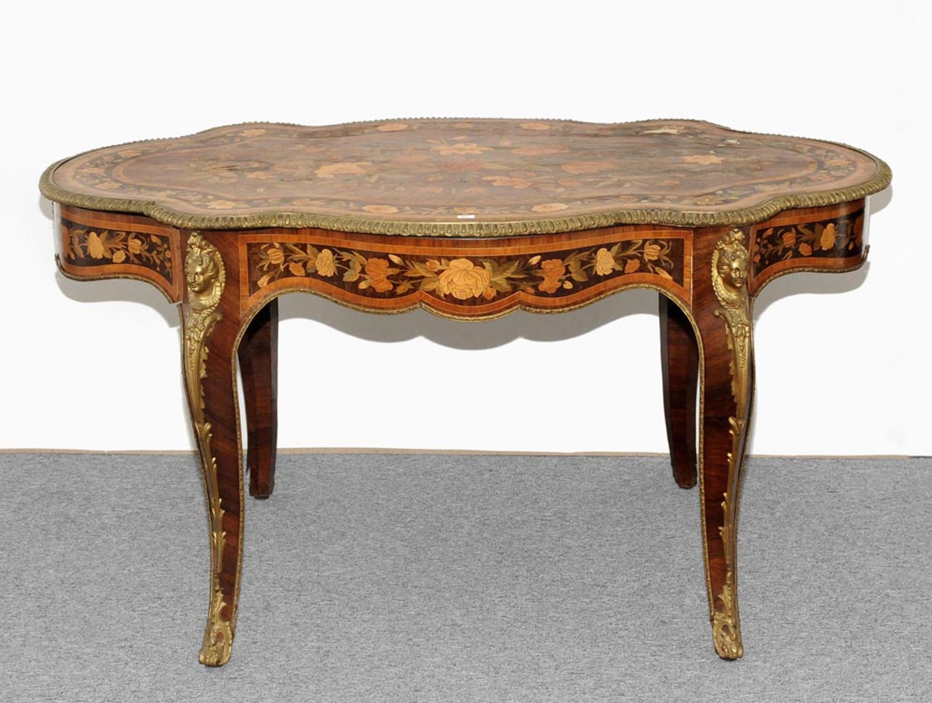 Tisch Napoleon III. Verschiedene Hölzer. Mehrfach geschwungenes Blatt mit Messingumrandung. Ovale,