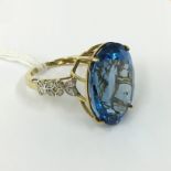 9CT GOLD & BLUE TOPAZ RING WITH 16 DIAMONDS TO THE SHOULDERS - SIZE M/N