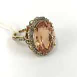 18CT YELLOW GOLD RING SET WITH A 15CT MORGANITE STONE SURROUNDED WITH DIAMOND WITH A DIAMOND