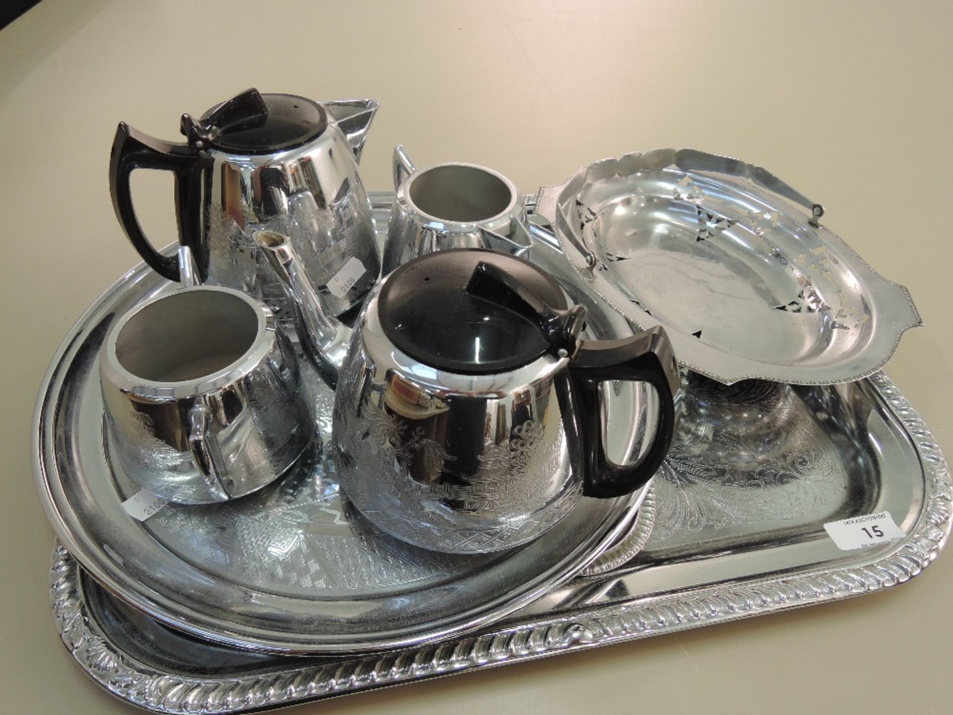 A tray of stainless steel and plated ware
