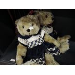 Two Millennium collection teddy bears and rocking chair