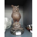 A cast bronzed effect figure modelled as an owl, signed M Nardini